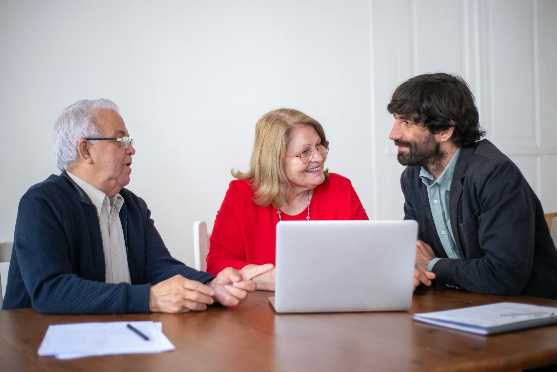 A working meeting between adult professionals reviewing economic documents
